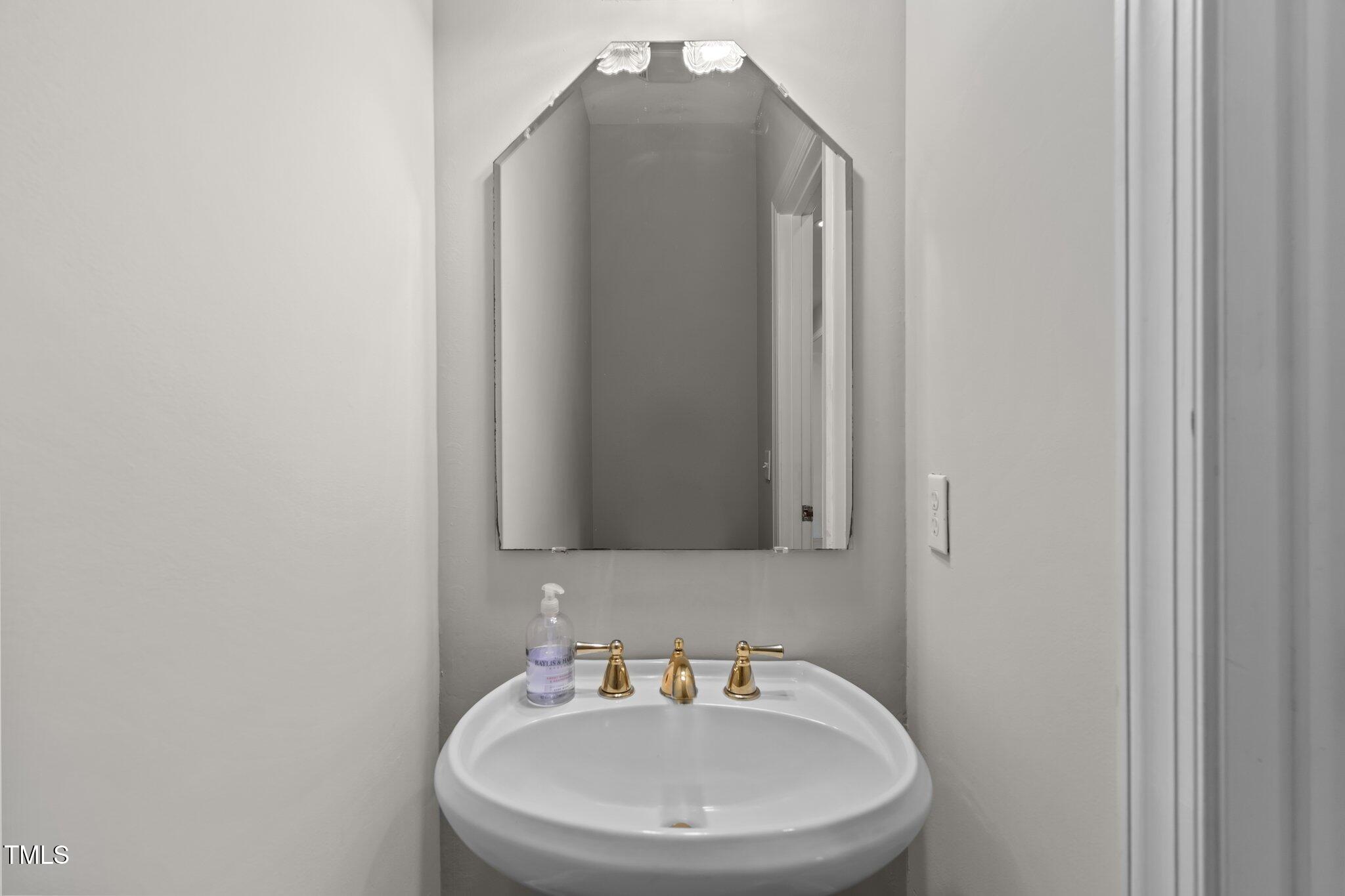 3556 Iris Street Wilmington, NC 28409 - Photo 23 of 52 a bathroom with a sink and a mirror