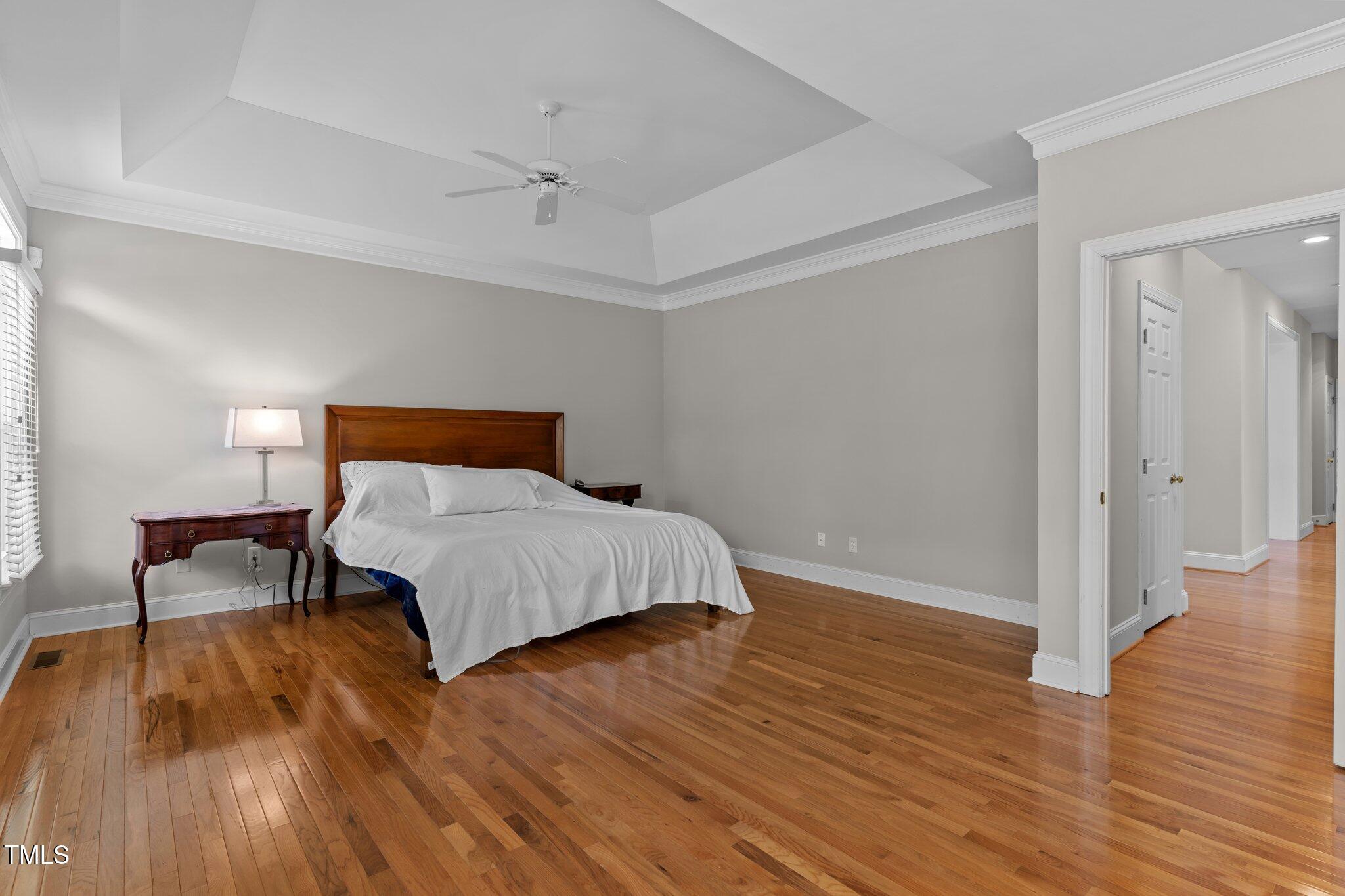 3556 Iris Street Wilmington, NC 28409 - Photo 24 of 52 a bedroom with a bed and wooden floor