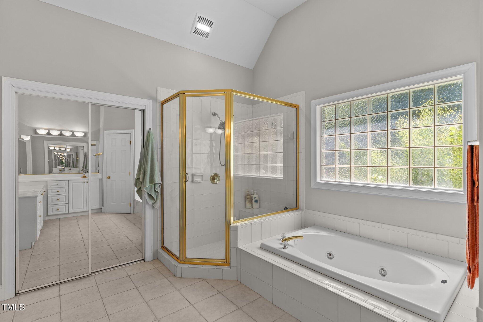 3556 Iris Street Wilmington, NC 28409 - Photo 27 of 52 a bathroom with a tub a sink and a shower