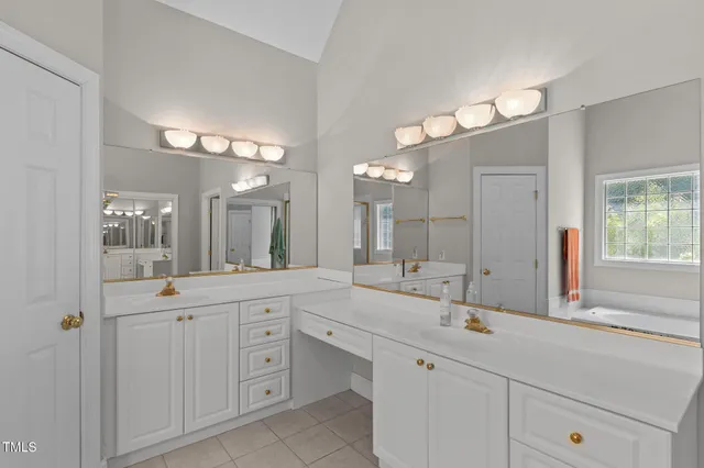 a bathroom with a tub a sink and a shower