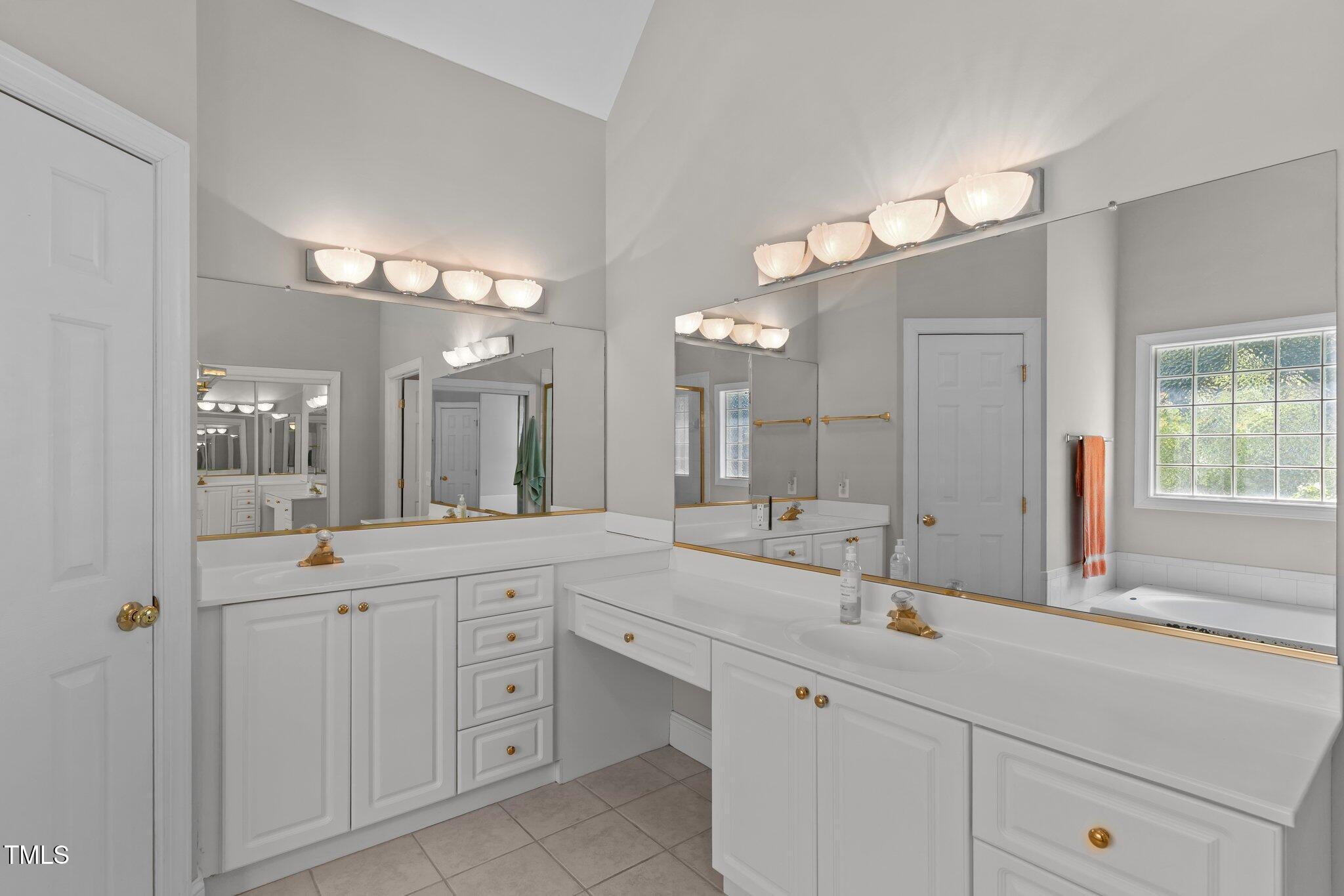 3556 Iris Street Wilmington, NC 28409 - Photo 28 of 52 a bathroom with a sink vanity and a mirror