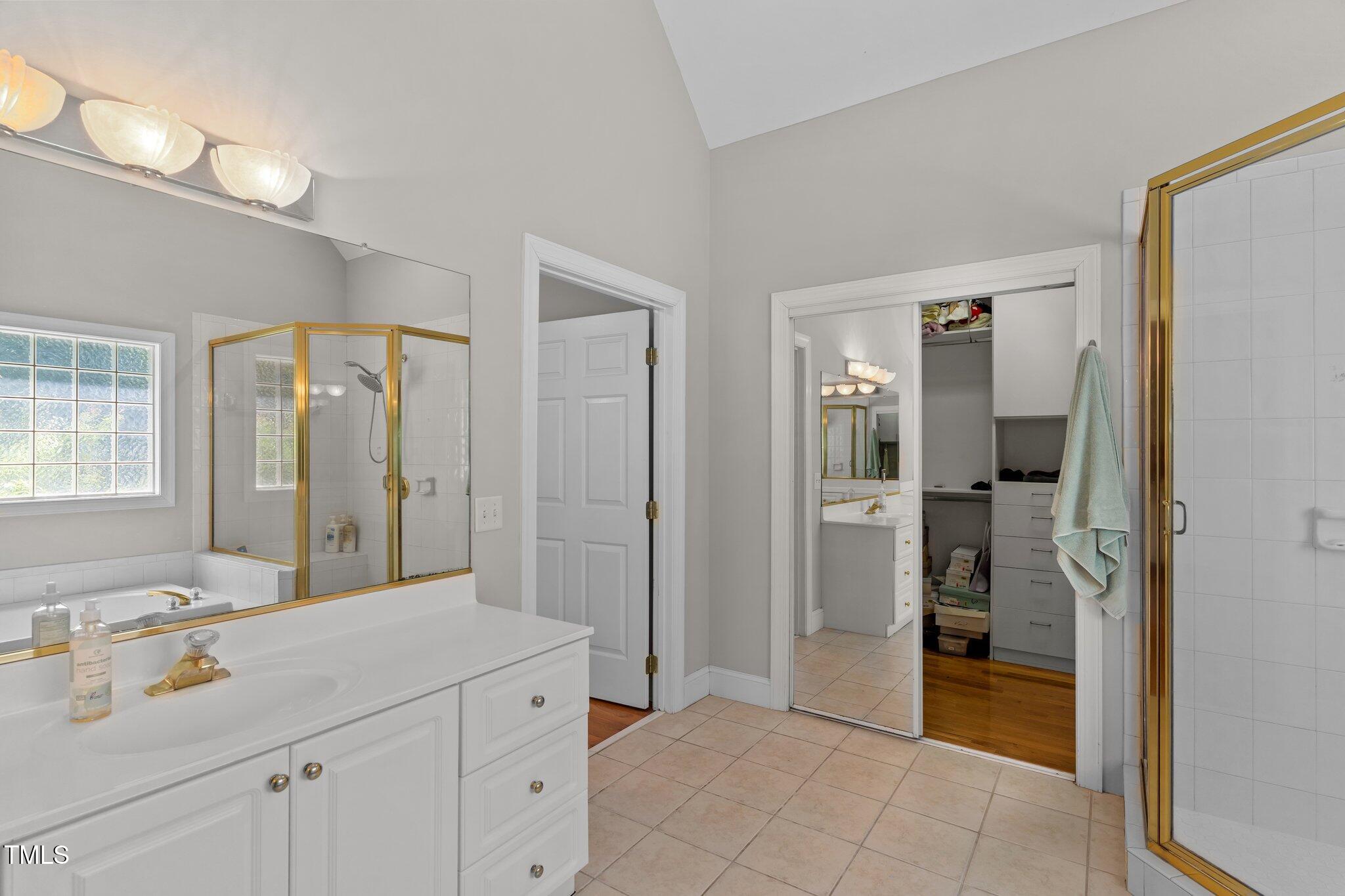 3556 Iris Street Wilmington, NC 28409 - Photo 29 of 52 a spacious bathroom with a shower sink and mirror