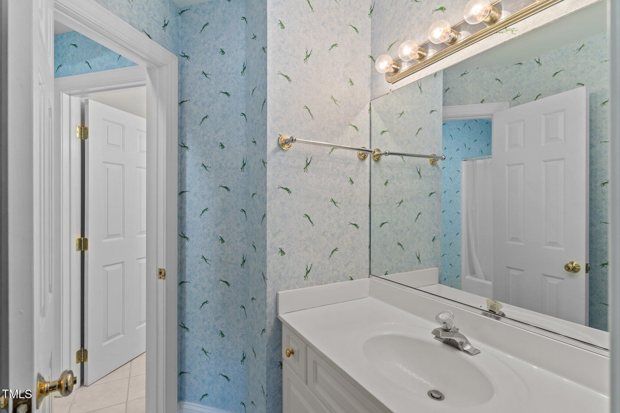 3556 Iris Street Wilmington, NC 28409 - Photo 38 of 52 a bathroom with a sink a shower and a mirror