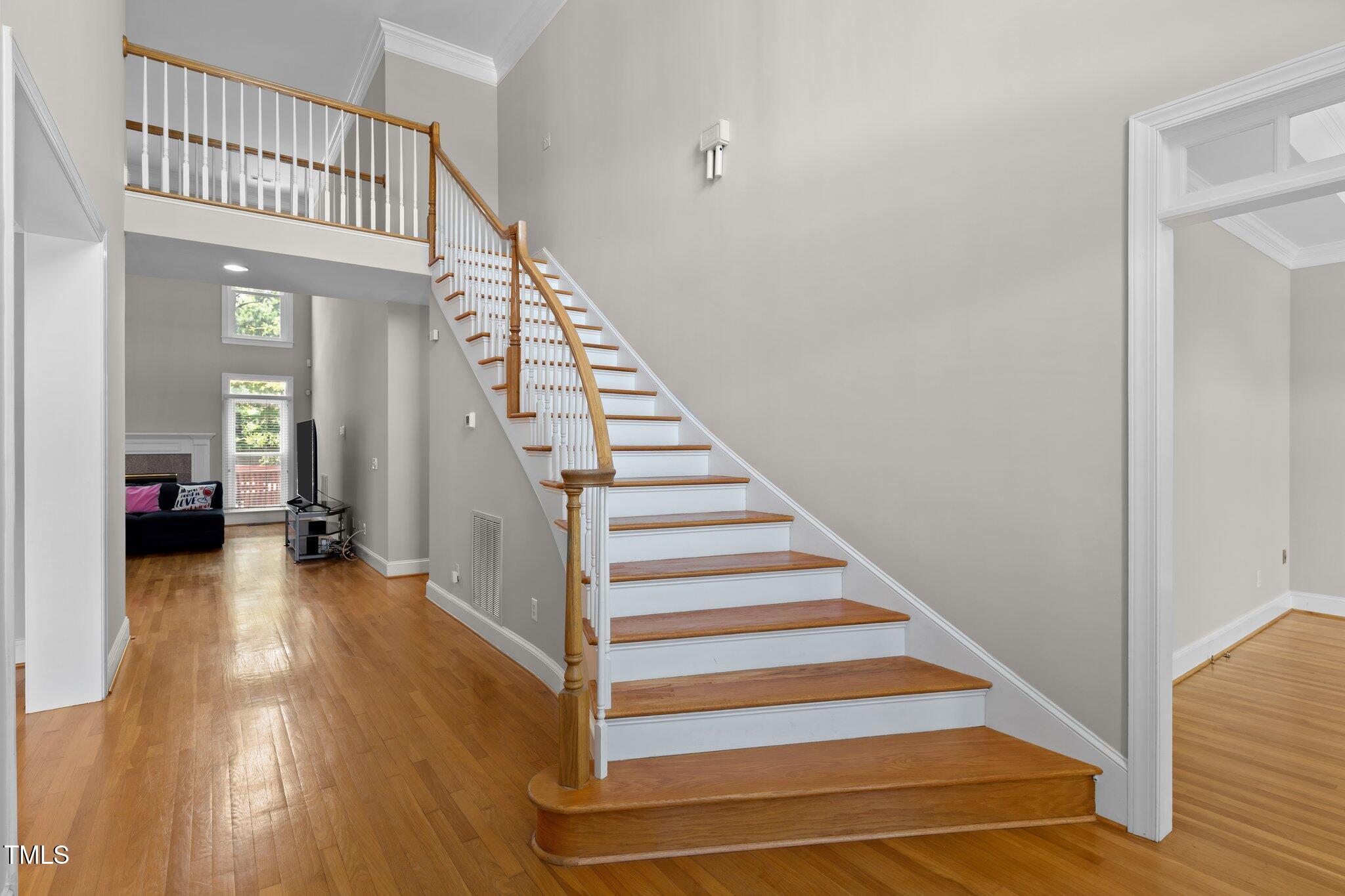3556 Iris Street Wilmington, NC 28409 - Photo 3 of 52 a view of a livingroom with wooden floor and stairs