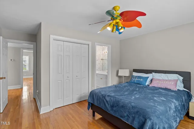 a bedroom with a bed and wooden floor