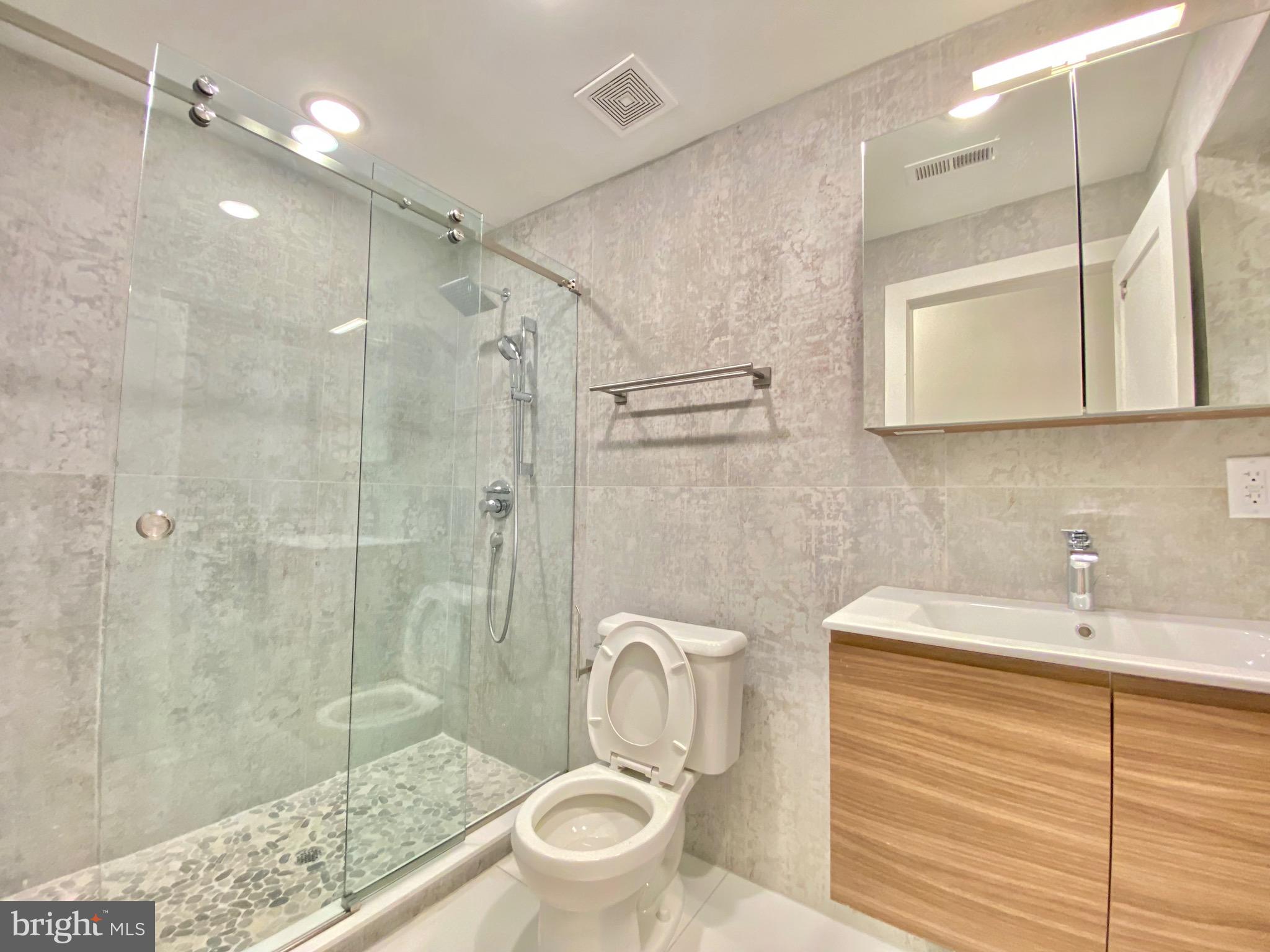 1824 Chestnut Street, Unit 1R Philadelphia, PA 19103 - Photo 9 of 12 a bathroom with a sink a toilet and shower