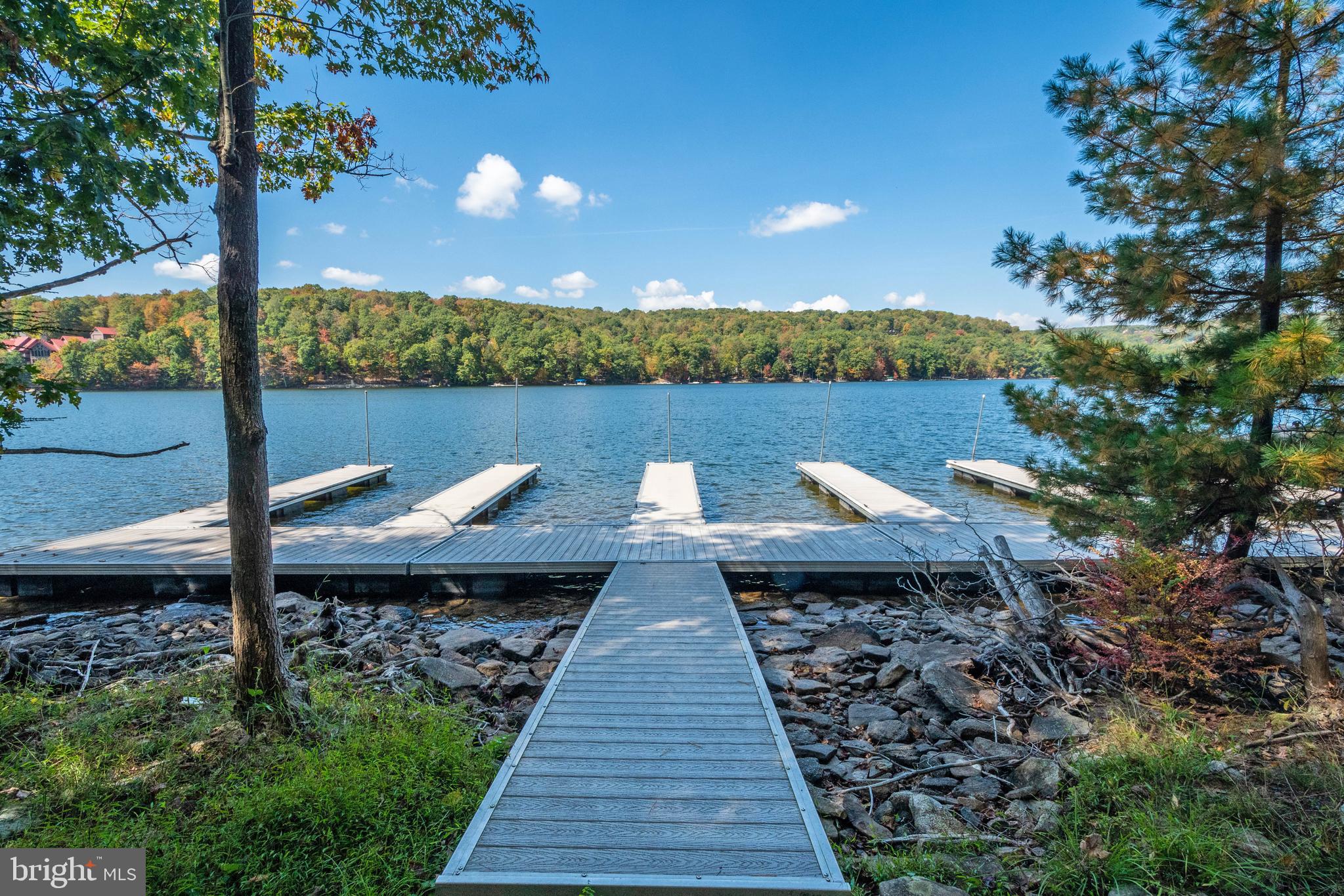 Edgewater Drive, Unit 4 Oakland, MD 21550 - Photo 14 of 16 a view of a lake with a table and chairs