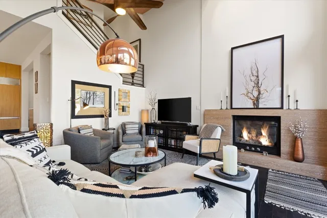 a living room with furniture a fireplace and a flat screen tv