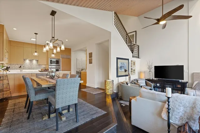 a kitchen with a table chairs and a chandelier