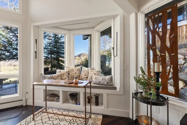 a balcony with chairs and wooden floor