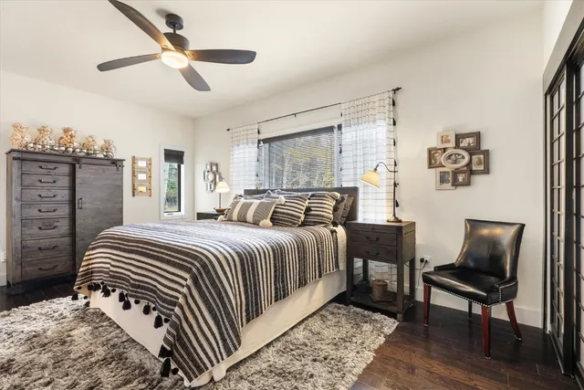 a bedroom with a bed and a flat tv screen on dresser
