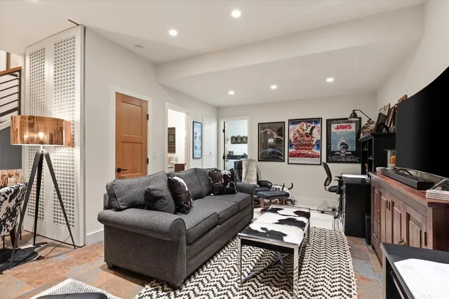 a living room with furniture a flat screen tv and a fireplace