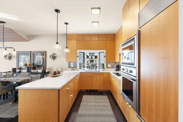a kitchen with stainless steel appliances granite countertop a sink and a stove