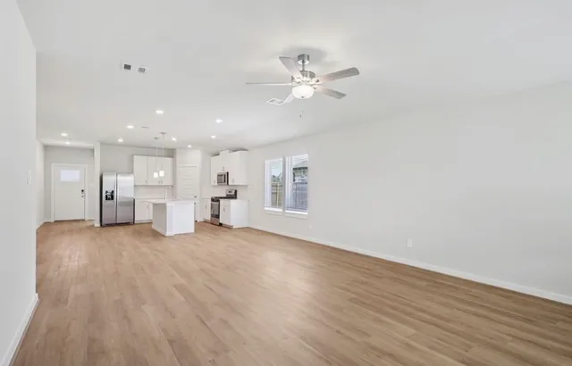 a view of a kitchen with wooden floor and a kitchen