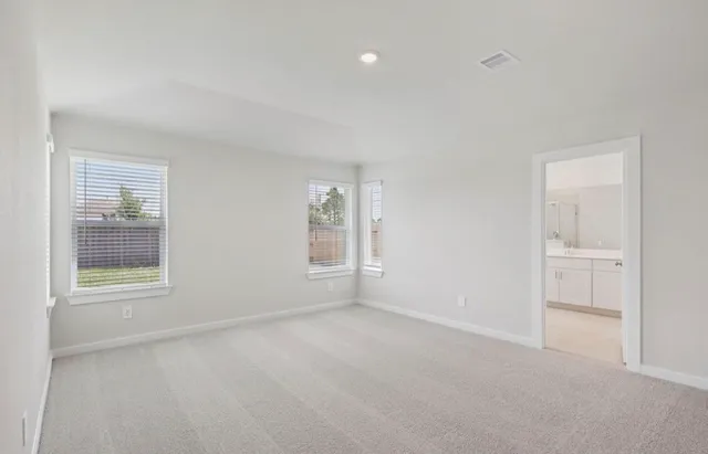 an empty room with windows and closet