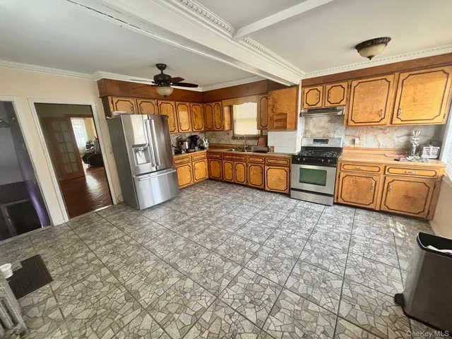 a open kitchen with granite countertop a stove refrigerator and sink