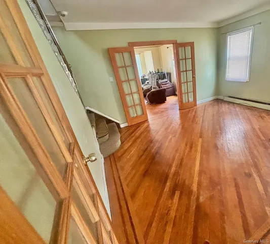 a view of an entryway with wooden floor
