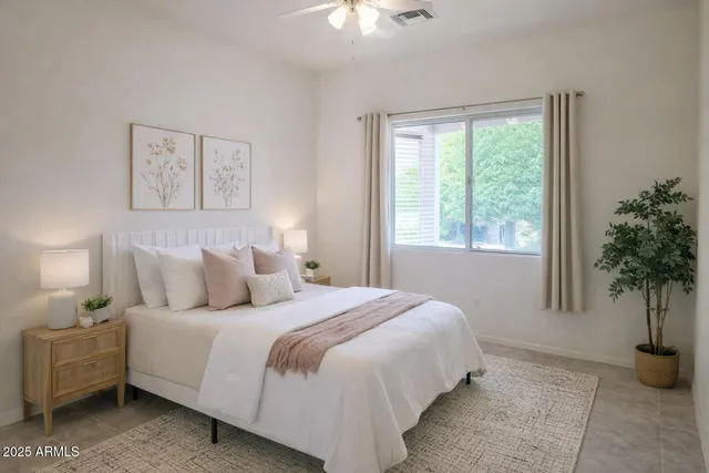 a bedroom with a bed and a potted plant