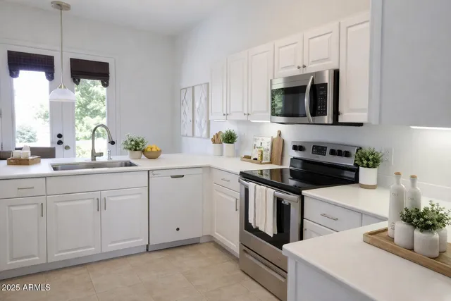a kitchen with stainless steel appliances white cabinets and a sink
