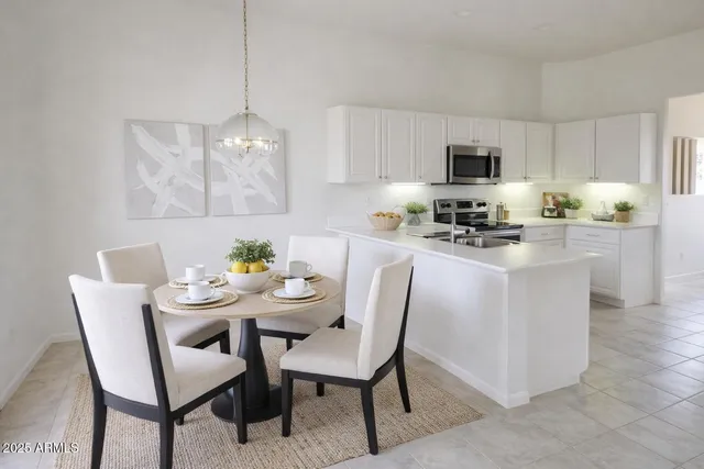 a dining room with furniture a chandelier a kitchen view and a stove