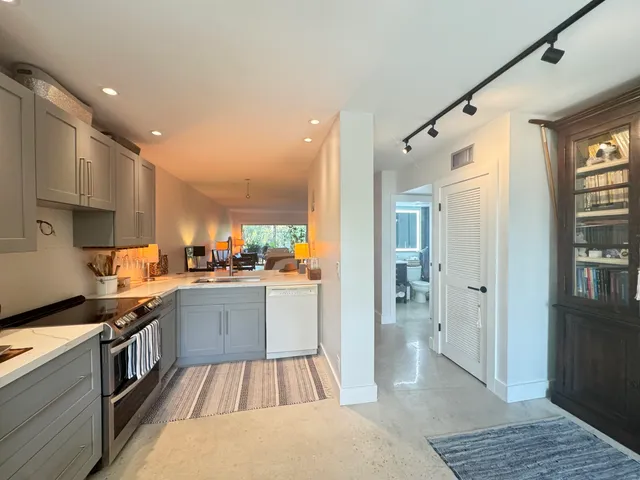 a kitchen with cabinets and wooden floor