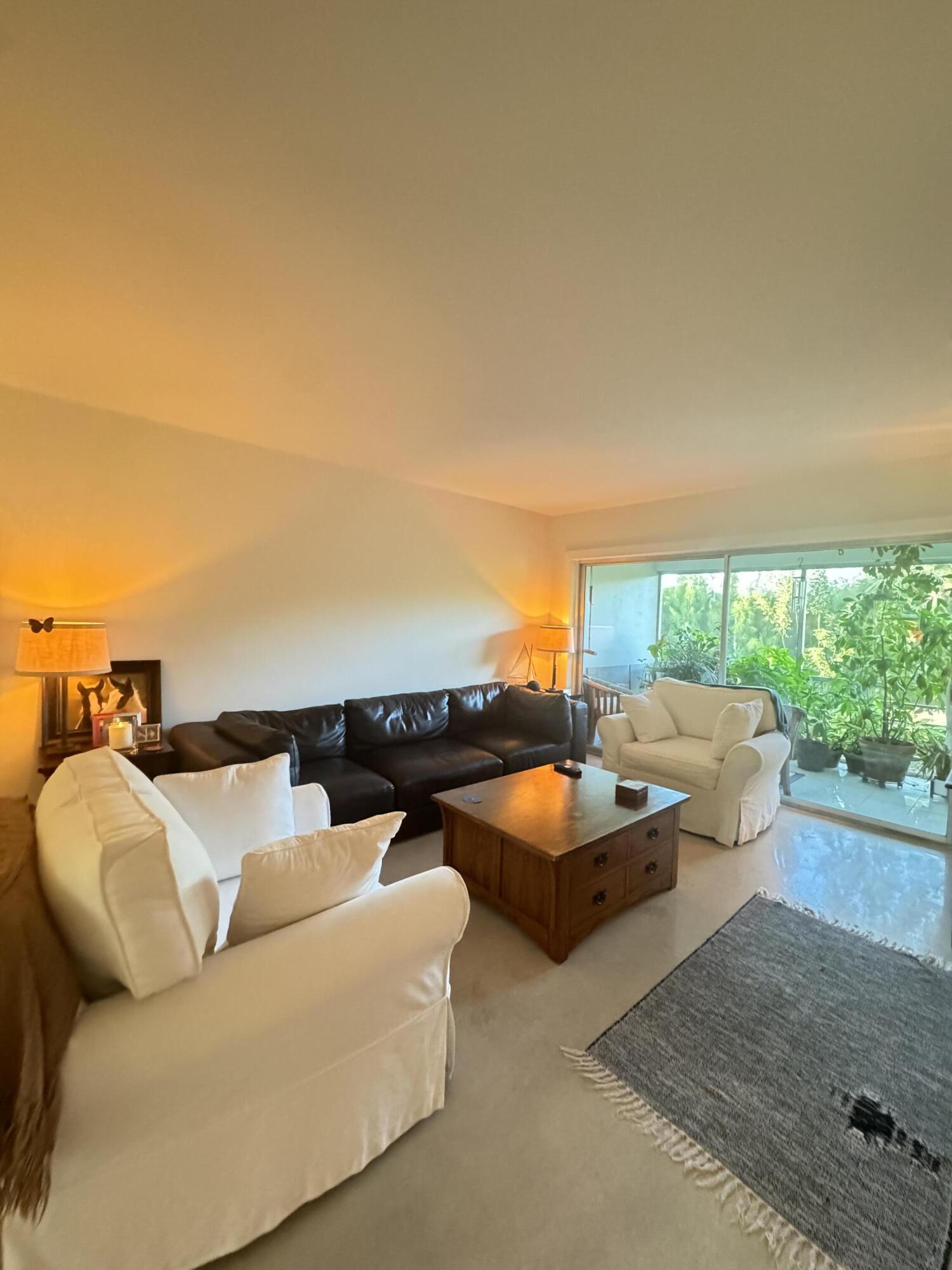 2320 Southwest 22nd Avenue, Unit 212 Delray Beach, FL 33445 - Photo 4 of 6 an outdoor living room with furniture and a flat screen tv