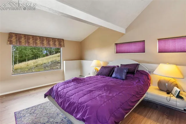 a bedroom with a large bed and a window