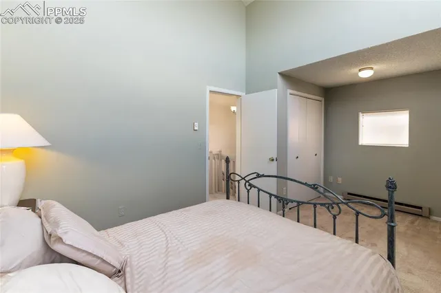 a bedroom with a bed and a large window