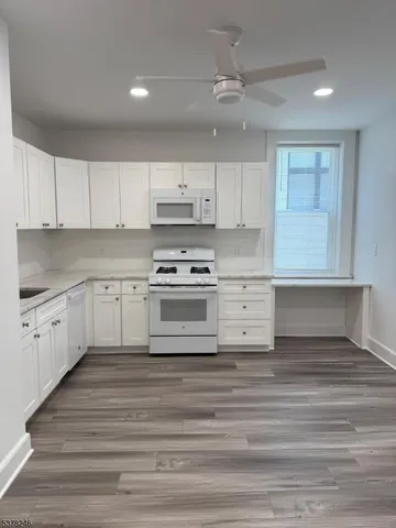 a kitchen with kitchen island sink cabinets and stainless steel appliances