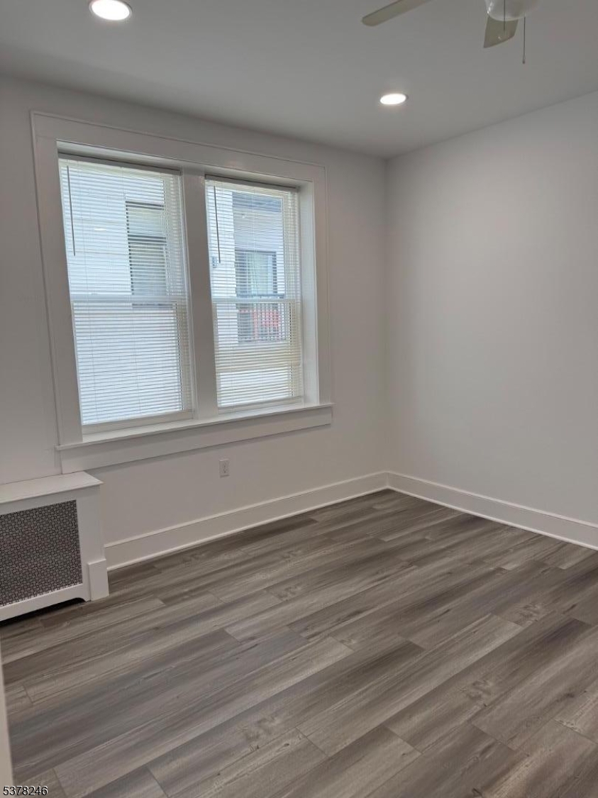 22 Baldwin Street, Unit 2 Montclair, NJ 07042 - Photo 18 of 20 a view of an empty room with wooden floor and a window