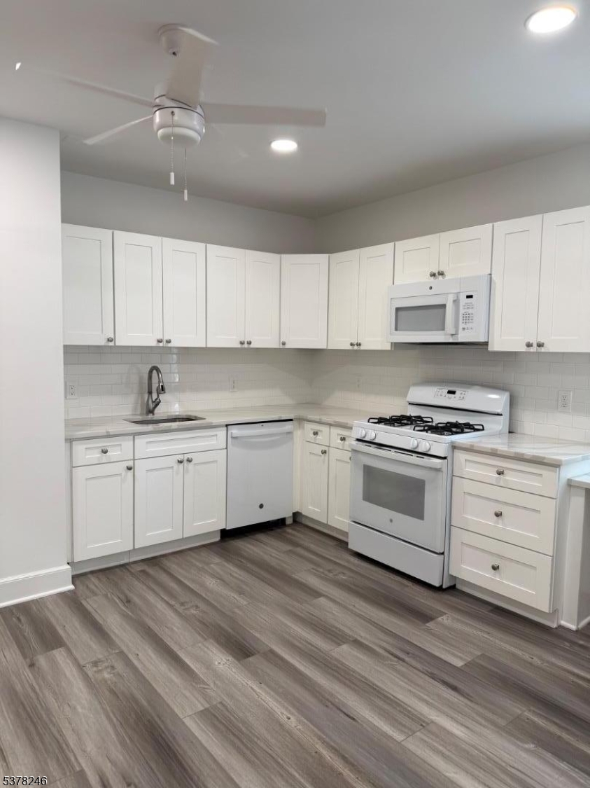 22 Baldwin Street, Unit 2 Montclair, NJ 07042 - Photo 2 of 20 a kitchen with white cabinets stainless steel appliances and sink