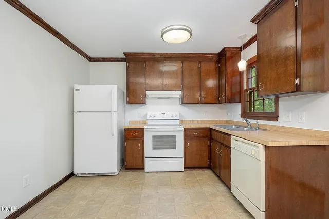 a kitchen with a stove a sink and a refrigerator