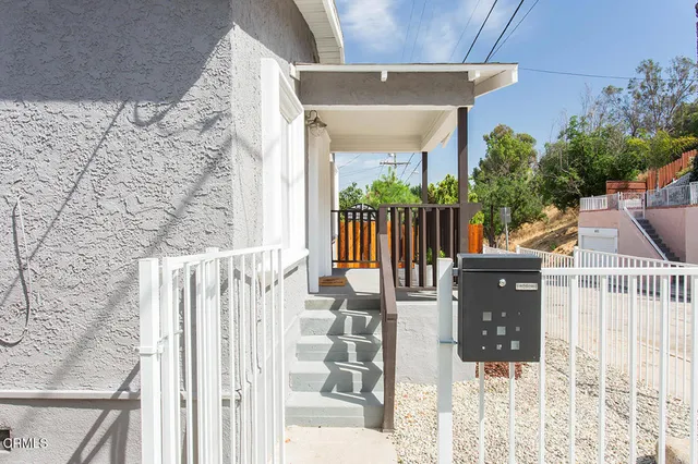 a view of a patio with table and chairs and wooden floor