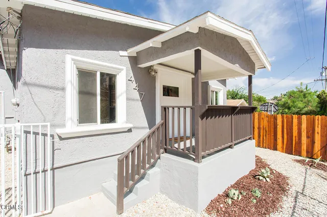 a front view of a house with wooden fence