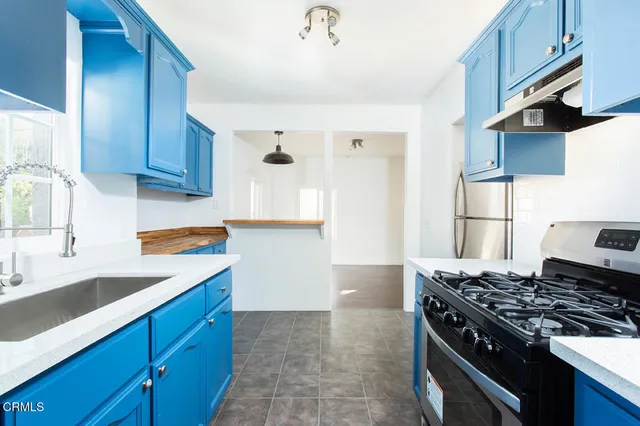 a kitchen with granite countertop a stove and a sink