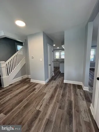 a large kitchen with stainless steel appliances granite countertop a stove a sink and a refrigerator