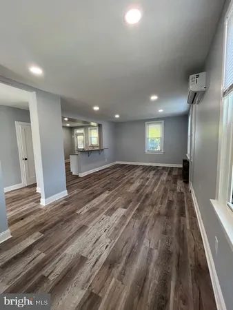 a large white kitchen with granite countertop a stove and a sink