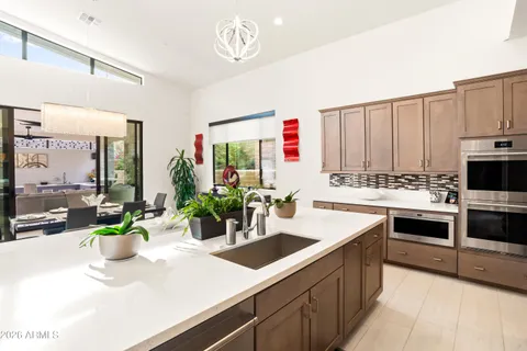 a living room with furniture and a dining table with kitchen view
