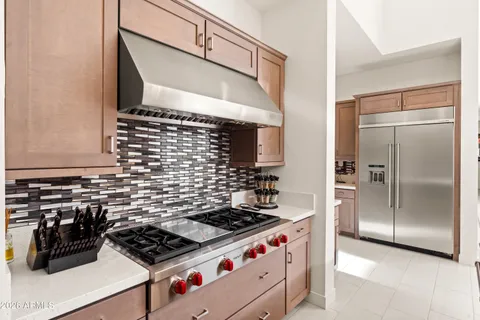 a kitchen with stainless steel appliances kitchen island granite countertop a stove a sink and a microwave