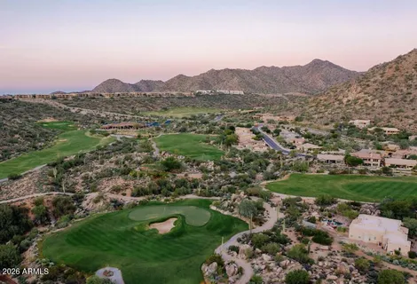 an aerial view of a house with a yard and sitting space