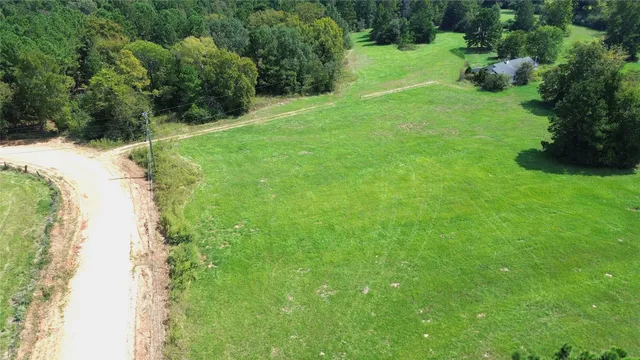 a backyard of a house with a yard and outdoor seating