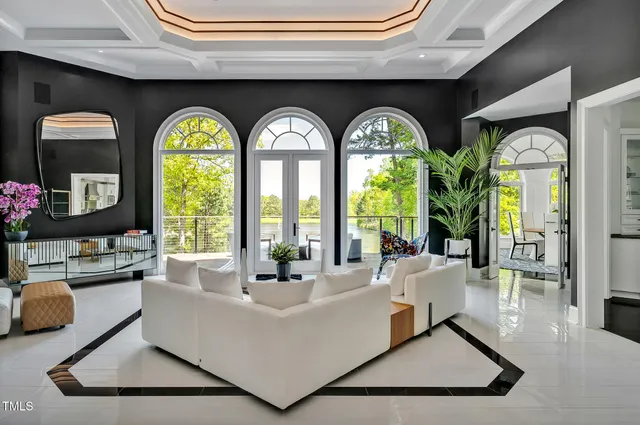 a living room with furniture and a painting on the wall