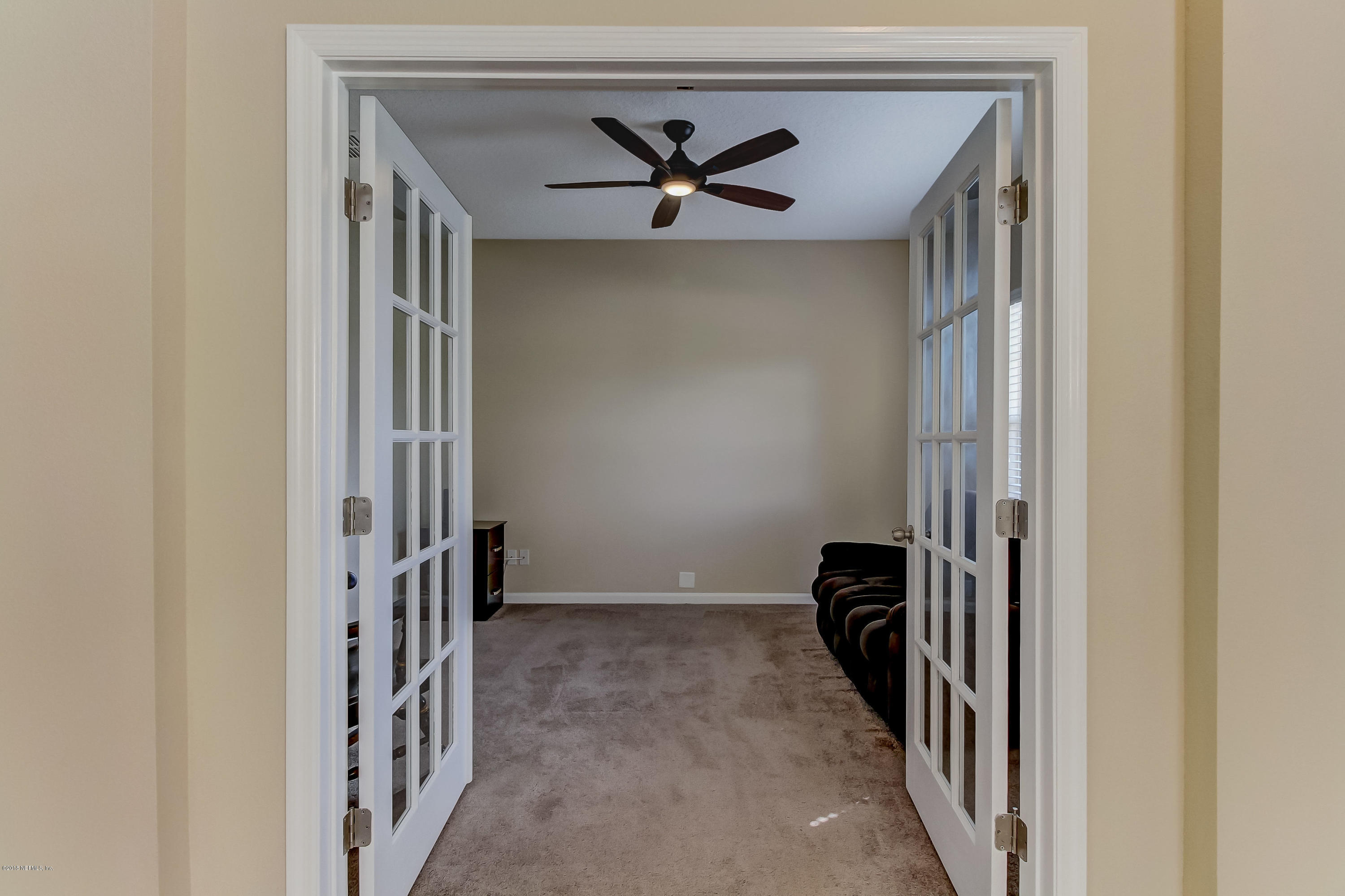 16480 Tisons Bluff Road Jacksonville, FL 32218 - Photo 13 of 80 a view of a hallway with a ceiling fan