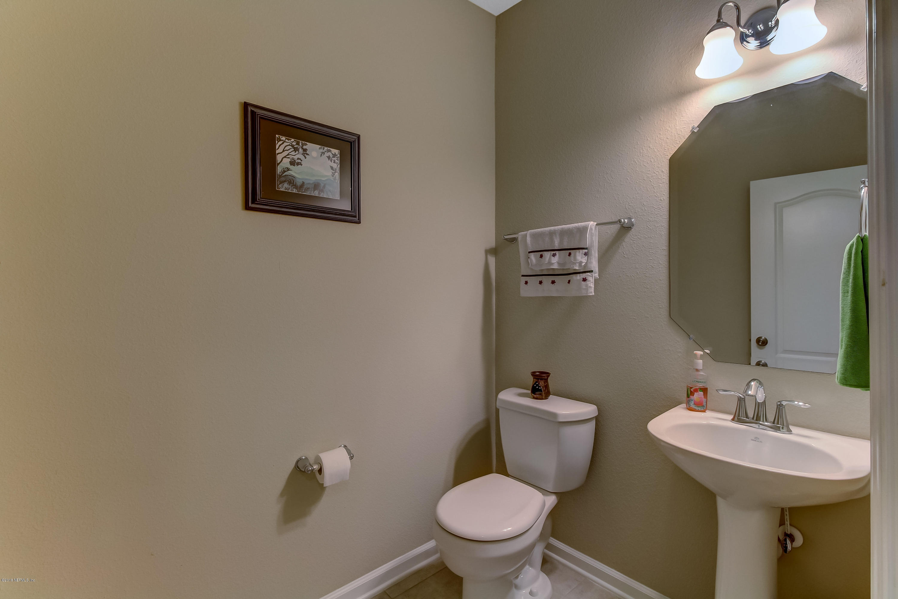 16480 Tisons Bluff Road Jacksonville, FL 32218 - Photo 26 of 80 a bathroom with a toilet a sink and mirror