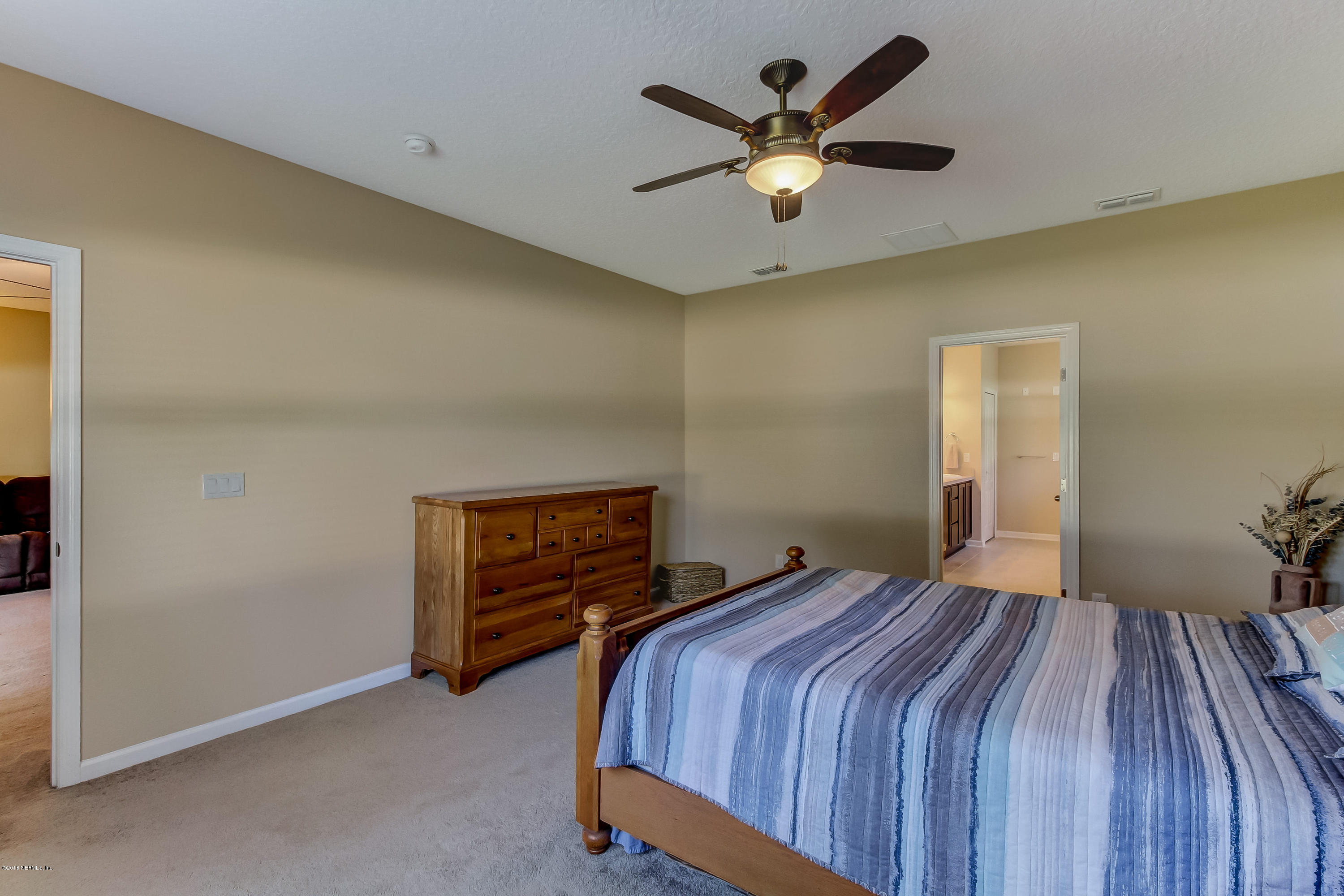 16480 Tisons Bluff Road Jacksonville, FL 32218 - Photo 31 of 80 a bedroom with a bed and a ceiling fan