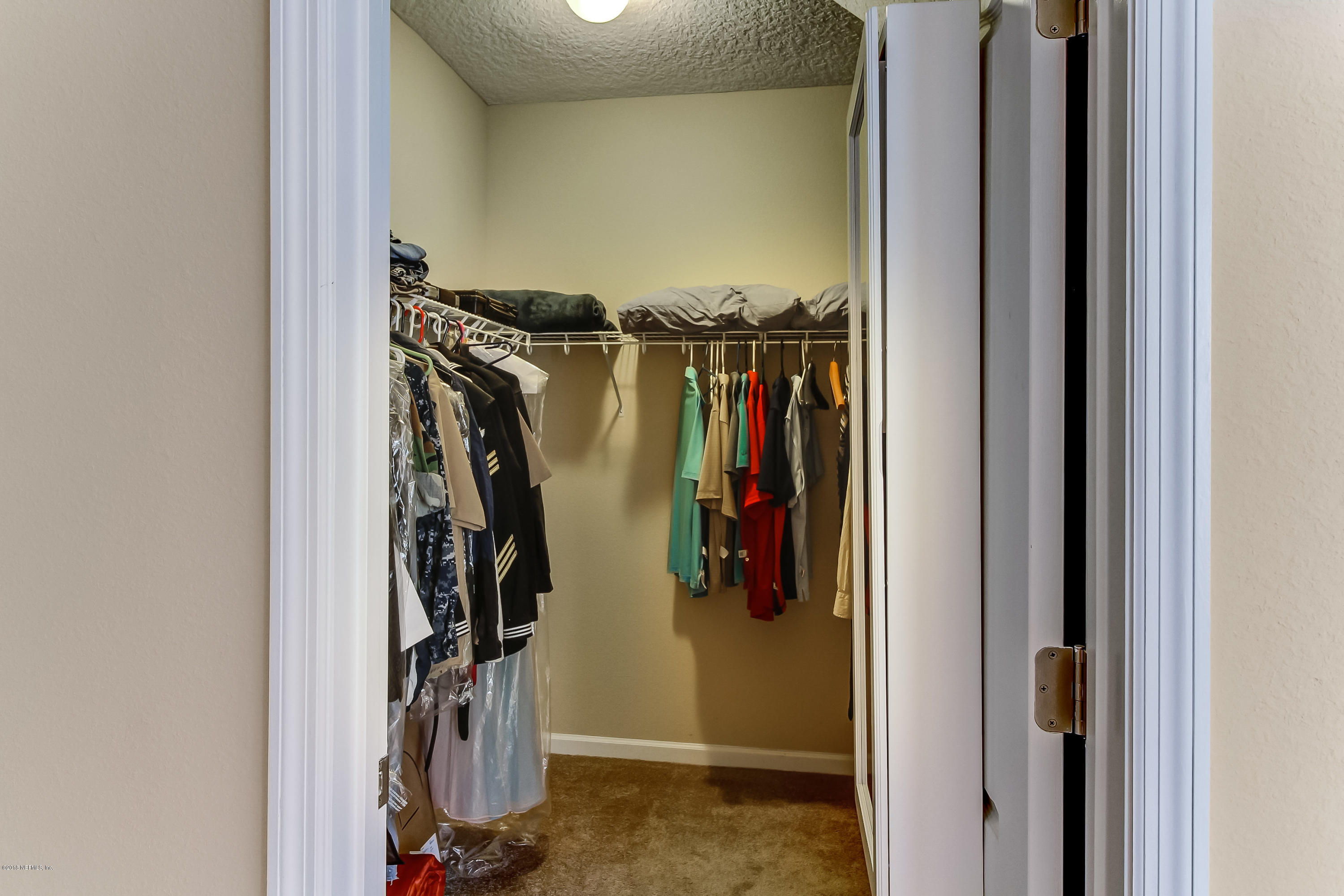 16480 Tisons Bluff Road Jacksonville, FL 32218 - Photo 32 of 80 a view of walk in closet with clothes