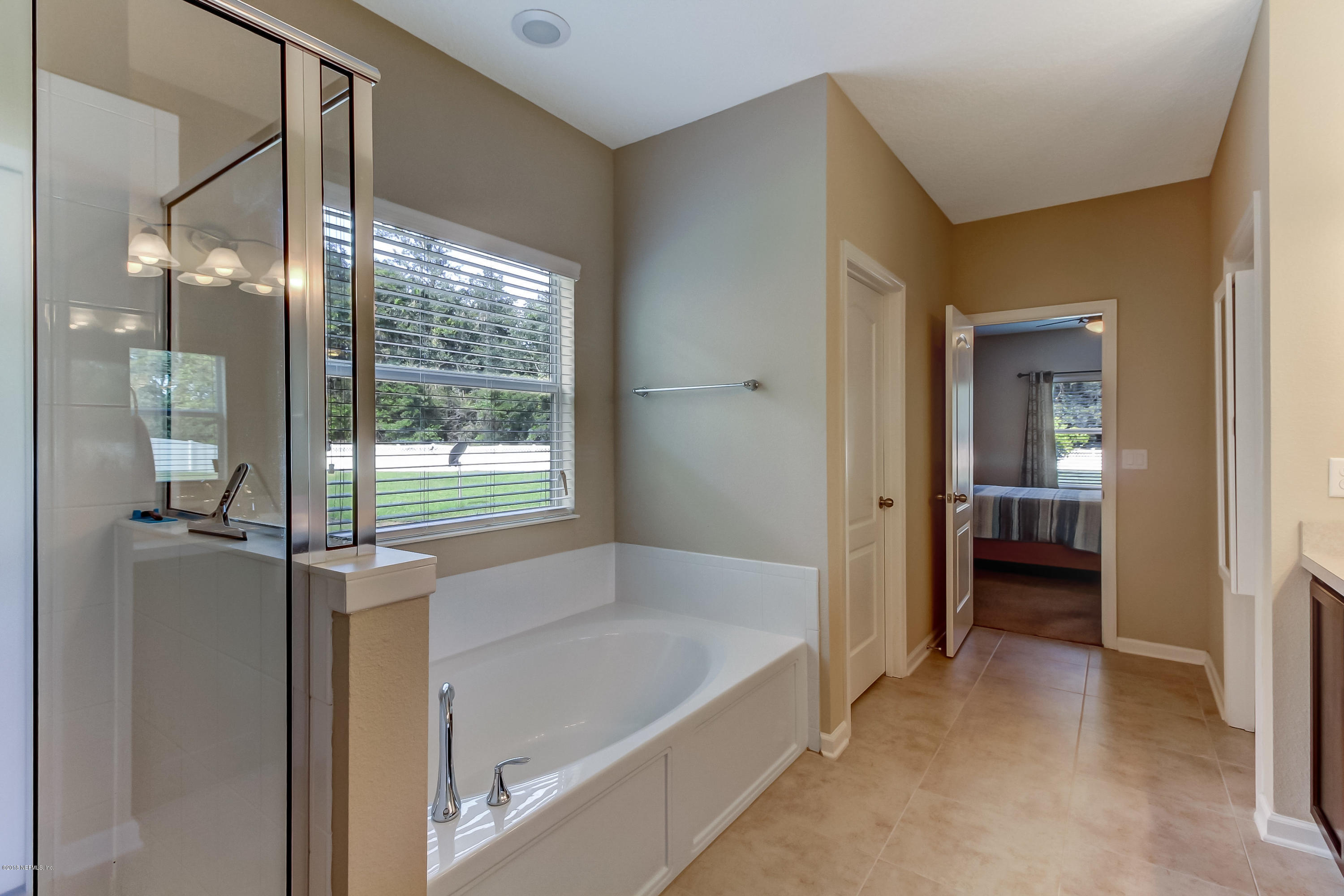 16480 Tisons Bluff Road Jacksonville, FL 32218 - Photo 35 of 80 a bathroom with a tub and shower