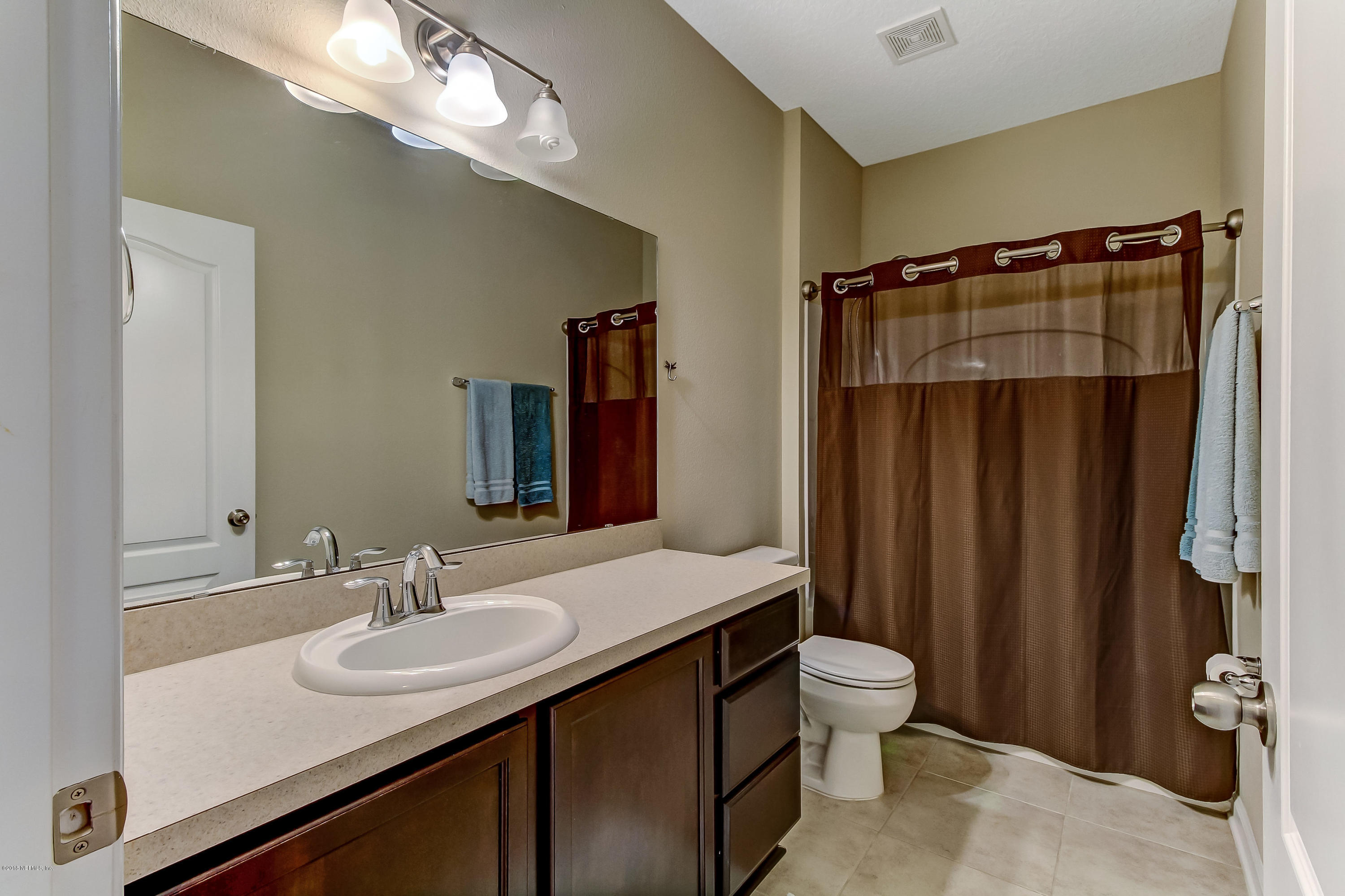 16480 Tisons Bluff Road Jacksonville, FL 32218 - Photo 41 of 80 a bathroom with a sink and a mirror