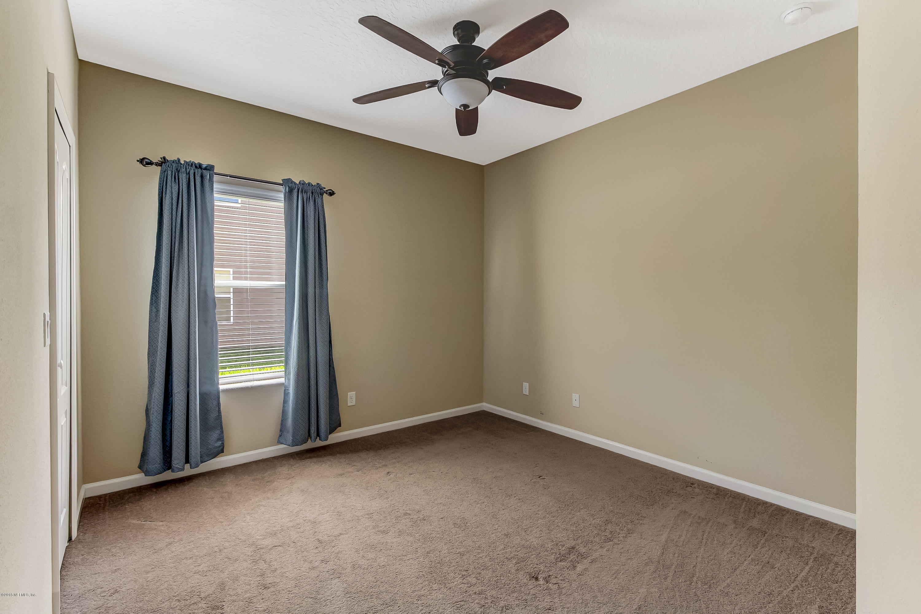 16480 Tisons Bluff Road Jacksonville, FL 32218 - Photo 42 of 80 an empty room with windows and fan
