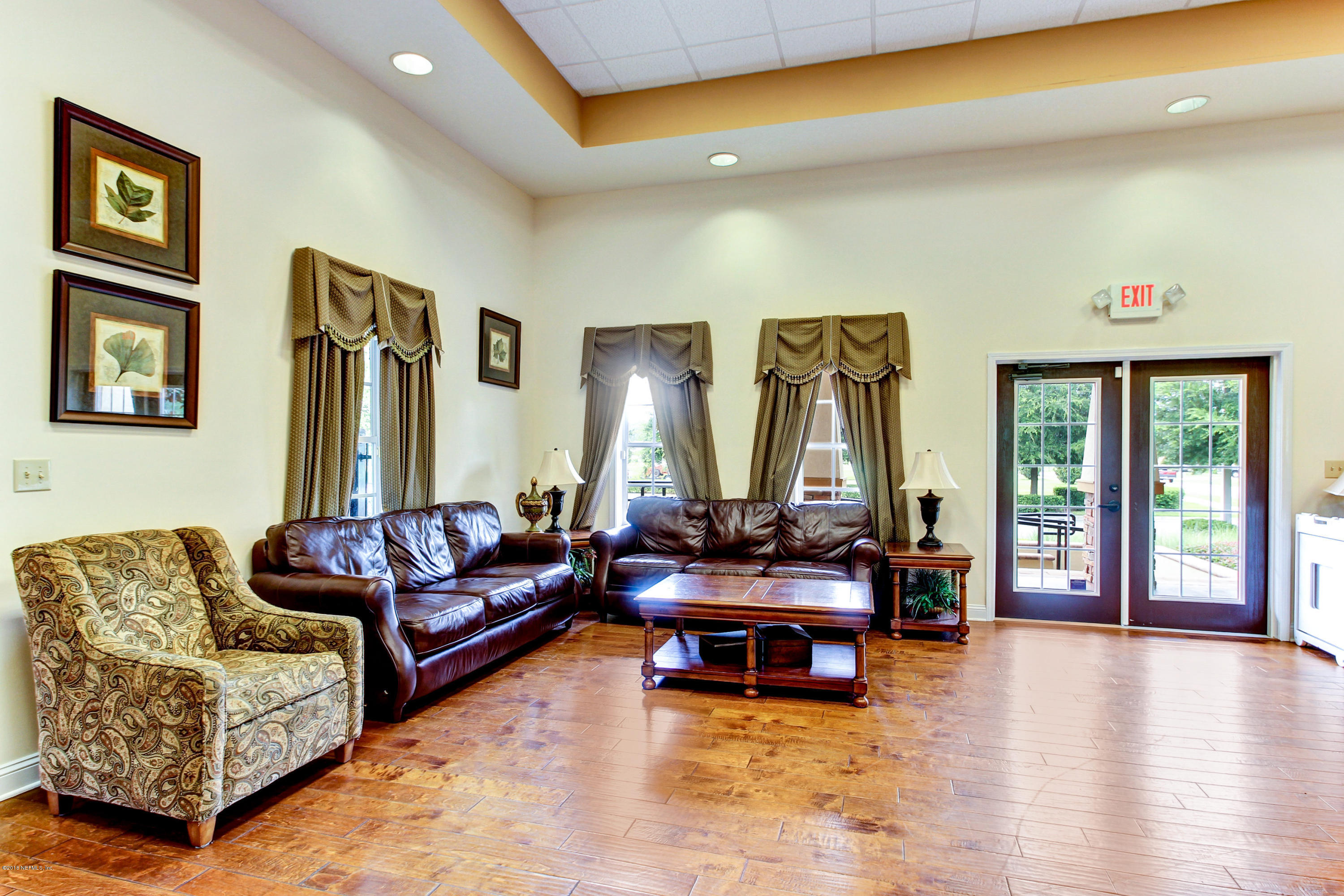 16480 Tisons Bluff Road Jacksonville, FL 32218 - Photo 69 of 80 a living room with furniture and floor to ceiling windows